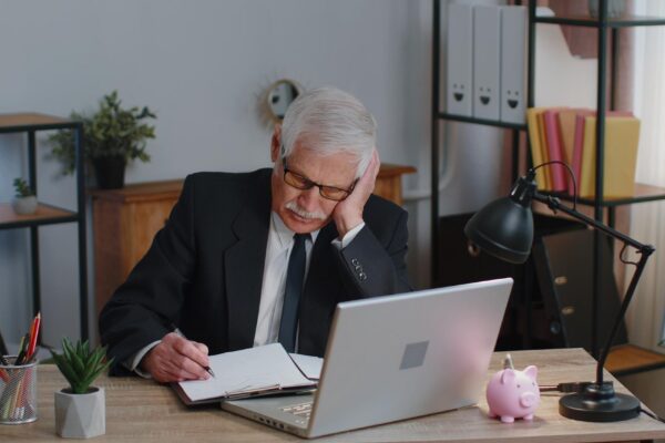 Portrait of young man using laptop at table