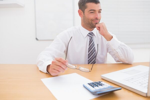 Businessman looking his laptop at his desk