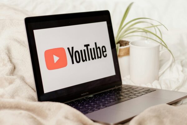 a laptop computer sitting on top of a bed