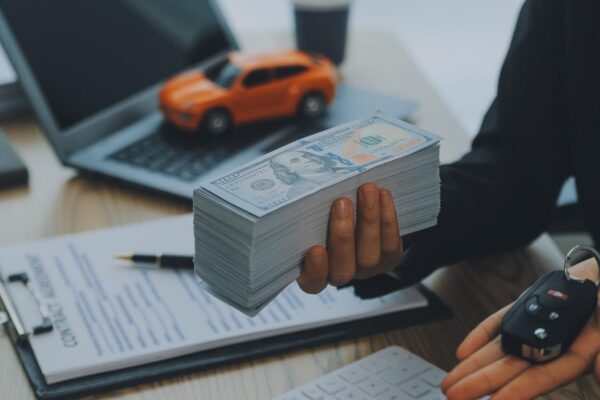 Salesman send key to customer after good deal agreement successful car loan contract buying or selling new vehicle