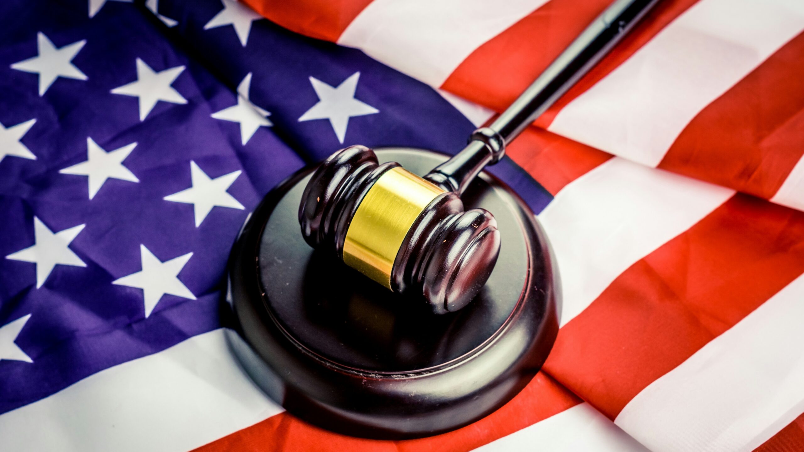 a judge's gavel on top of a flag