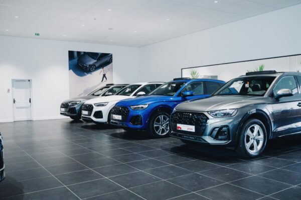 Cars are lined up in a showroom.