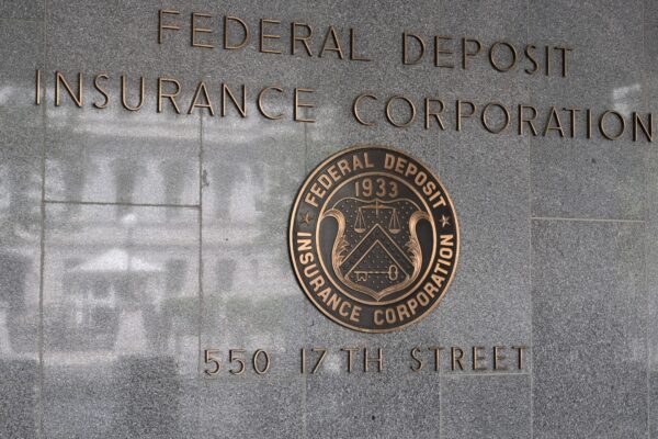 The sign for the Federal Deposit Insurance Corporation mounted on the exterior wall of a building. 550 17th Street NW, Washington, DC 20429.