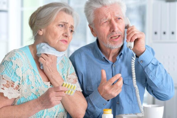 An elderly couple is sick and takes medication at home