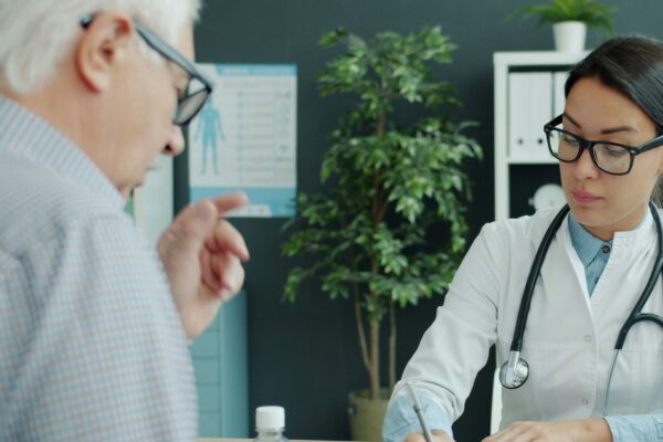 Doctor consults with elderly man and child.