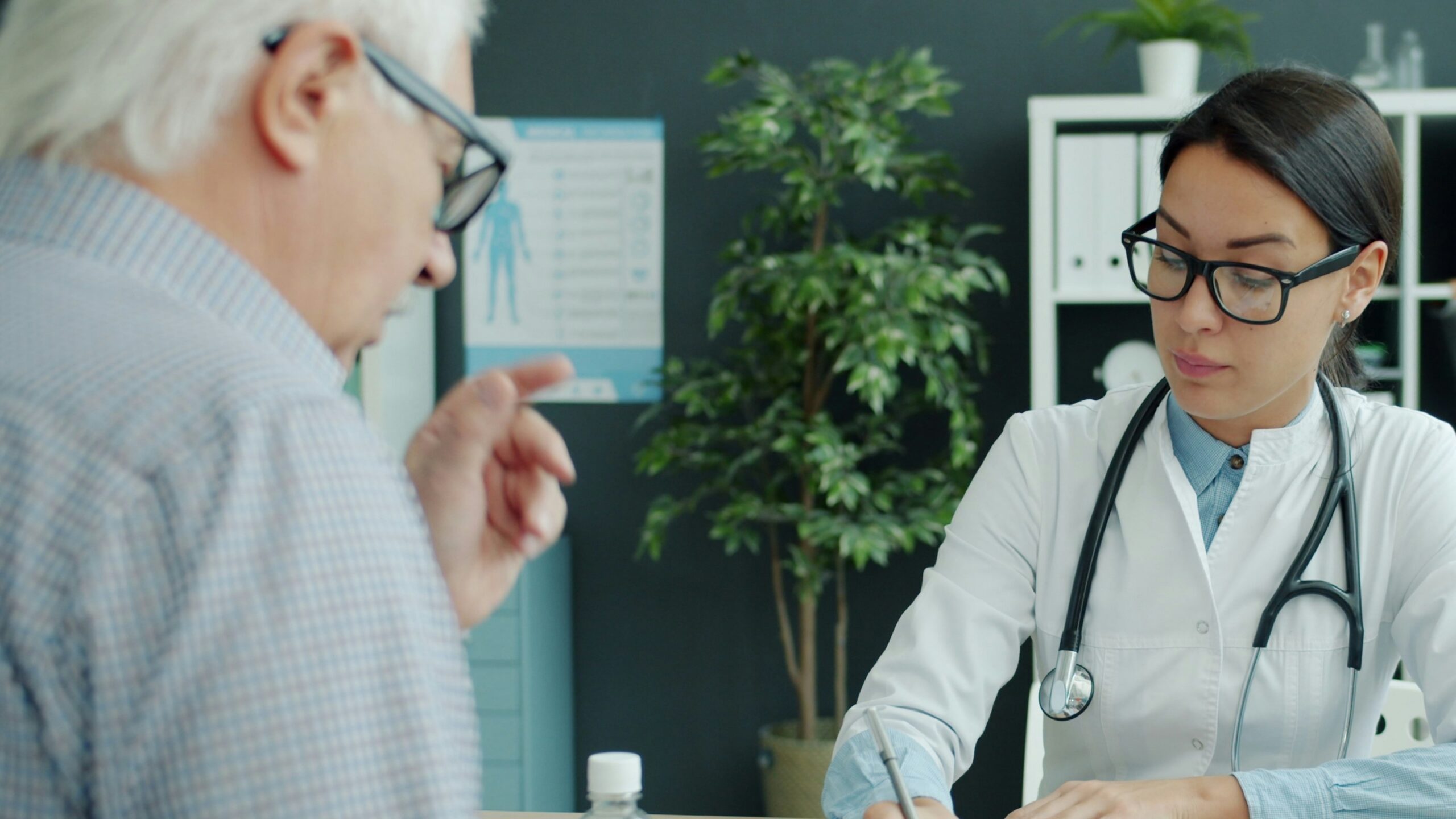 Doctor consults with elderly man and child.