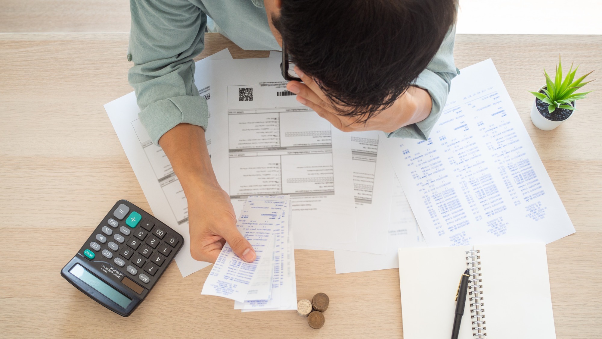 The butler worried hands touch forehead which has many expenses such as electricity bills, internet bills, mobile phone bills and credit card bills on hand, no money to pay. debts concept