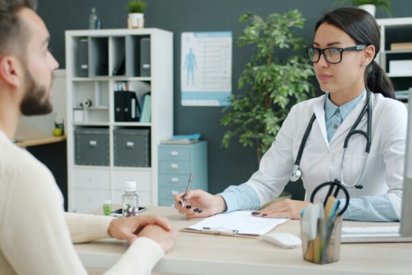 Doctor consulting with a patient in an office.