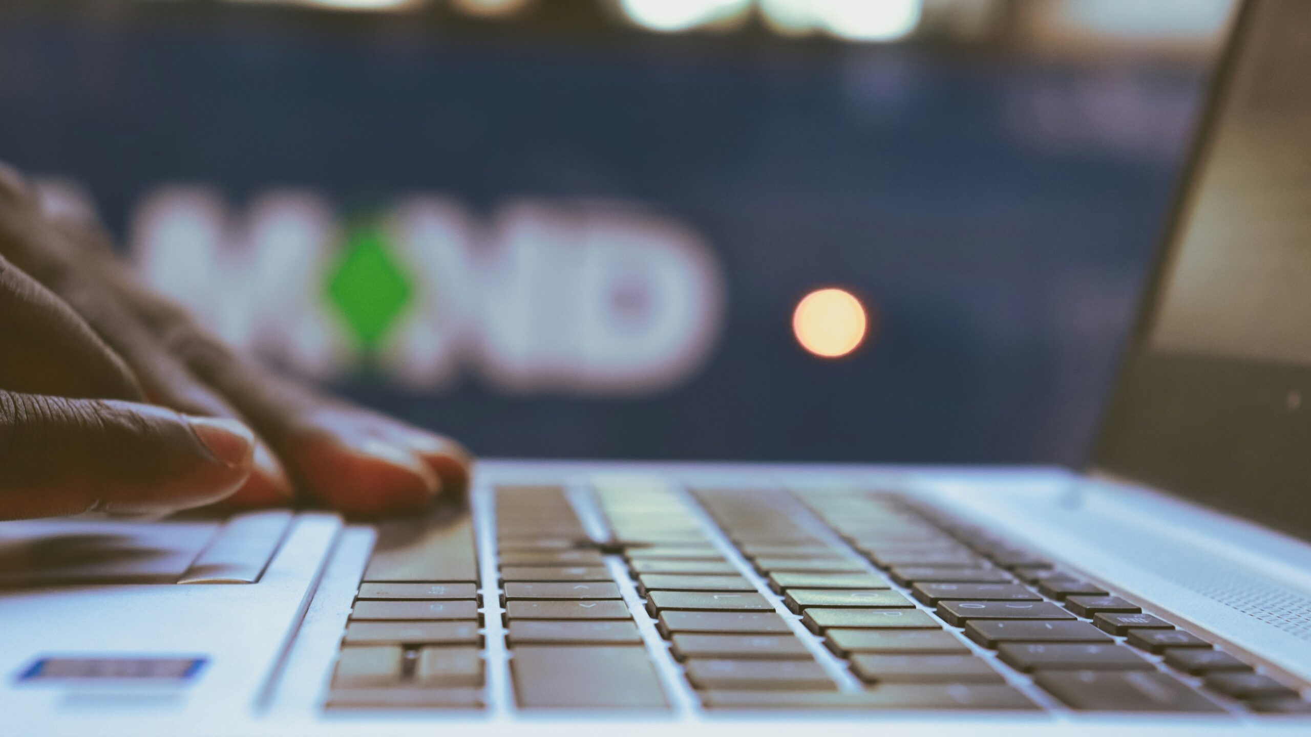 a close up of a person typing on a laptop