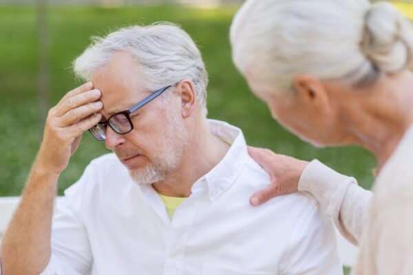 health stress old age and people concept senior man suffering from headache outdoors