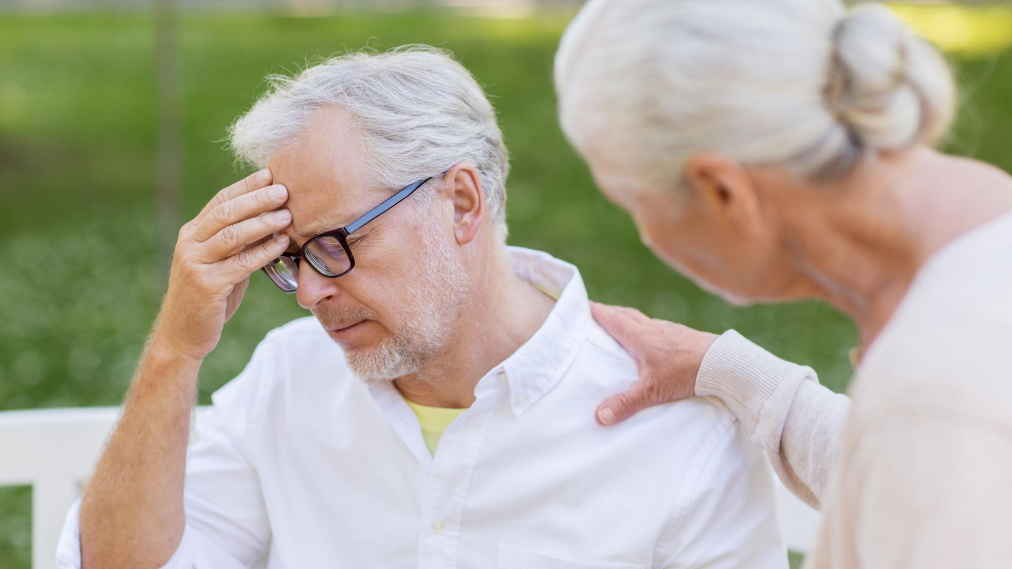health stress old age and people concept senior man suffering from headache outdoors