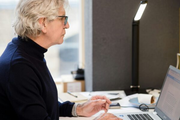 a woman sitting in front of a laptop computer