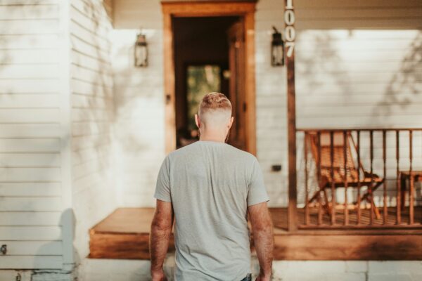 A man standing in front of a house