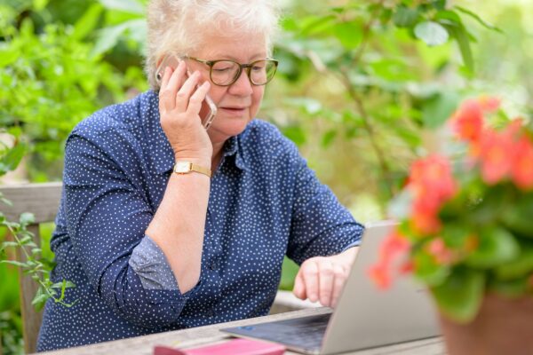 an old woman using a laptop