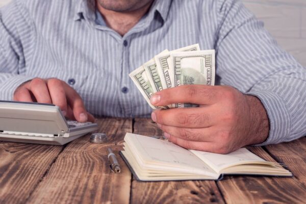 Businessman with calculator and dollars
