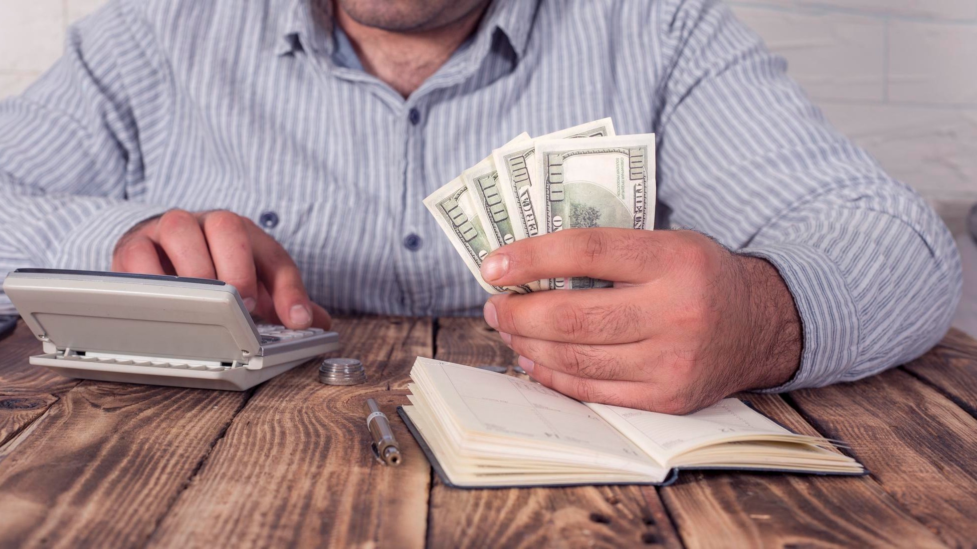 Businessman with calculator and dollars