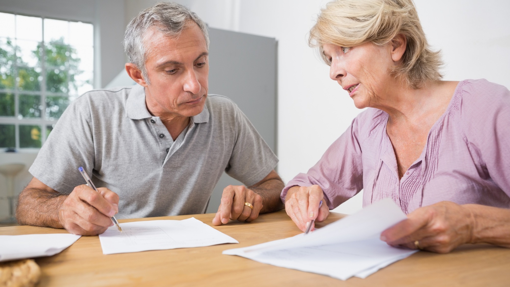 Couple discussing with documents