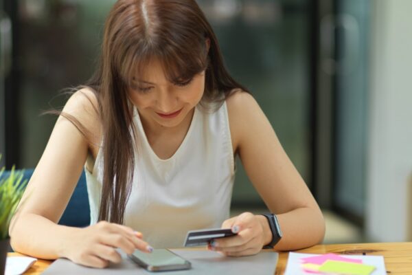female pay via online application installed credit card to provide cashless payment transaction