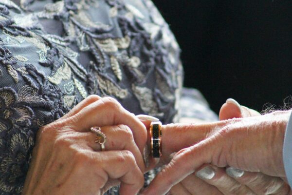 A close up of two people holding hands