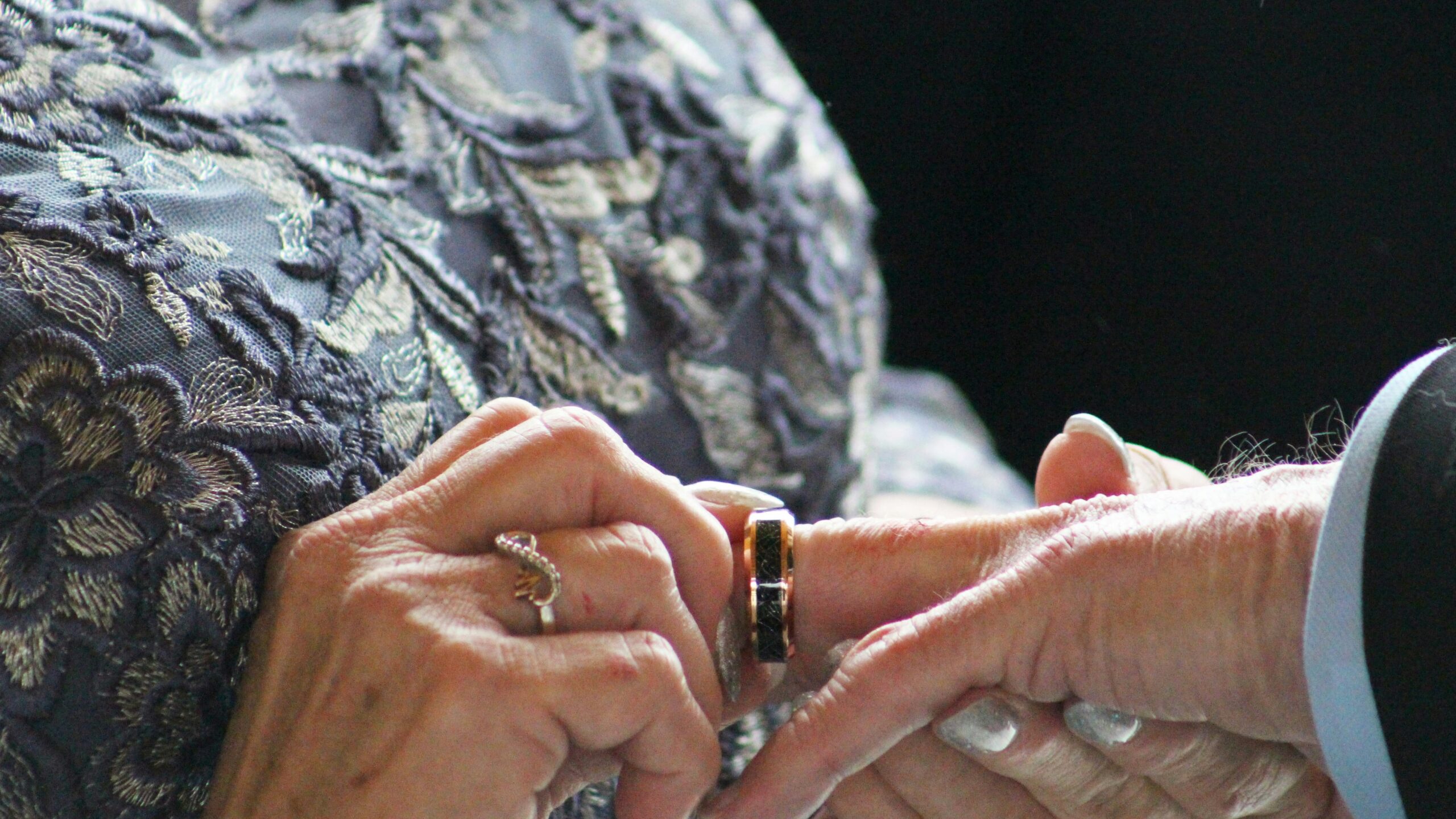 A close up of two people holding hands