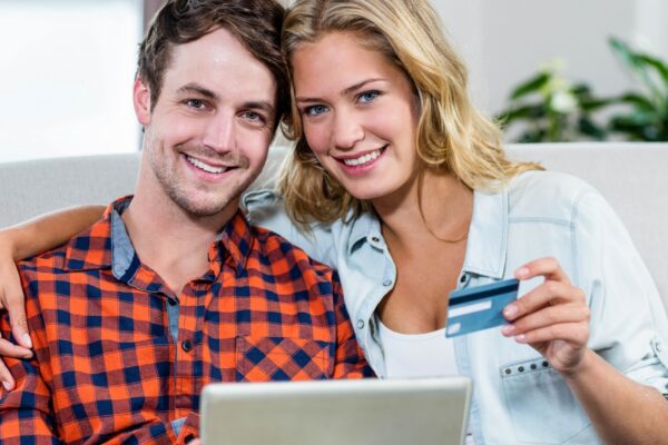 Couple paying with credit card on the couch
