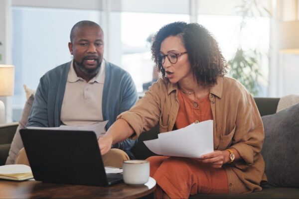 Home documents and senior couple with laptop budget and financial planning Apartment man and woman with paperwork taxes or retirement fund with internet connection and computer in lounge