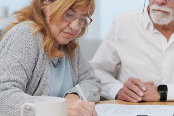 Senior couple insurance and contract with financial advisor and retirement plan to sign Document pension and business analyst with information and paperwork in office for signature of will