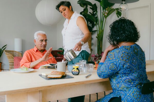 a group of people sitting around a table eating food