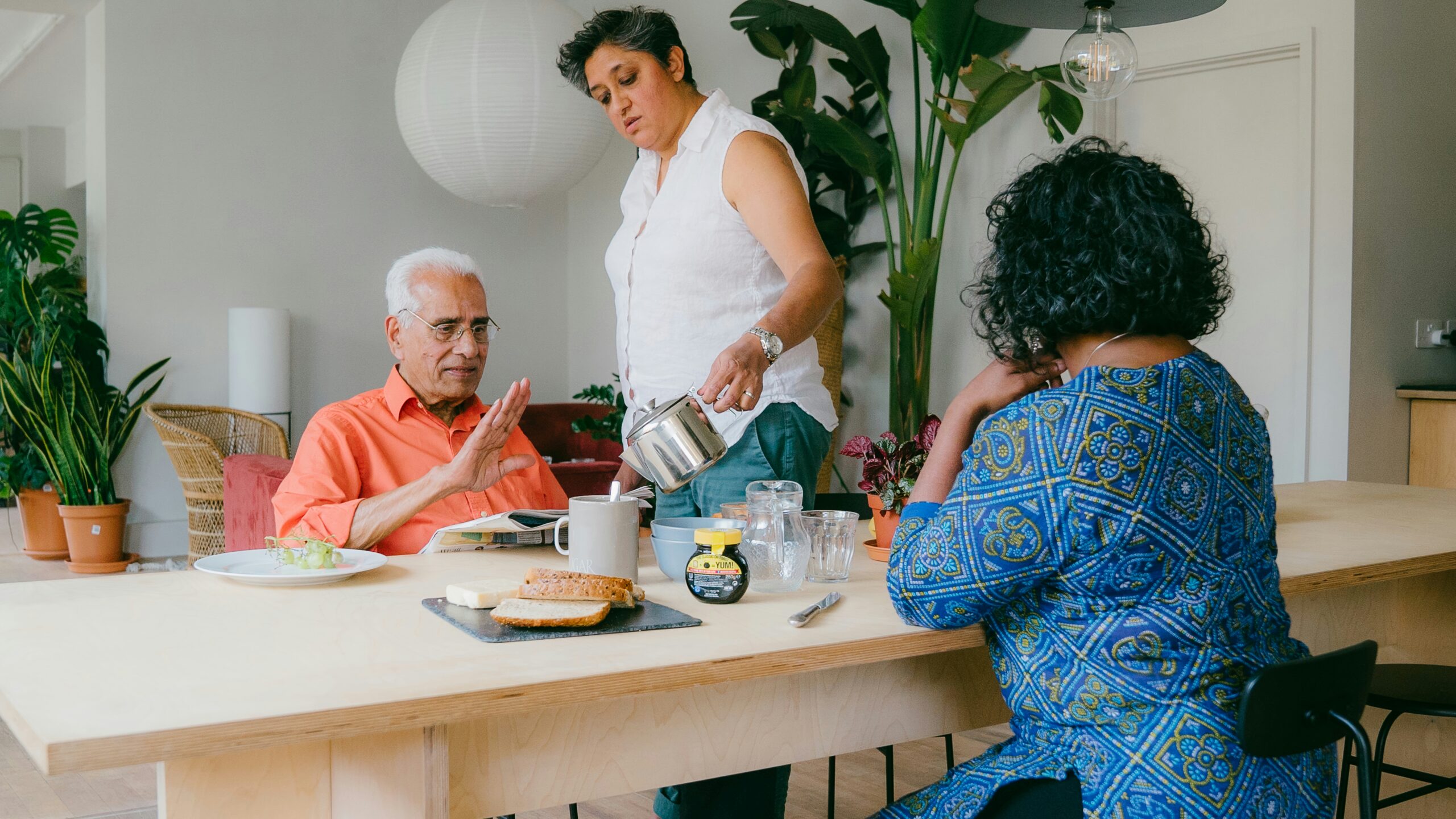 a group of people sitting around a table eating food