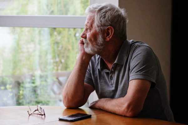 Senior retired man sitting at home alone while quarantine