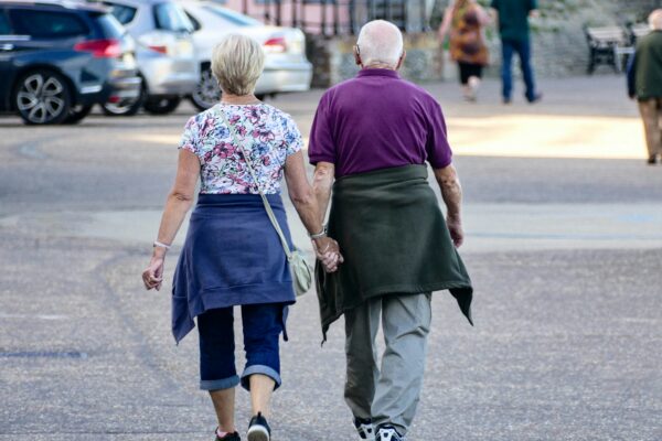 man and woman walking on the street during daytime