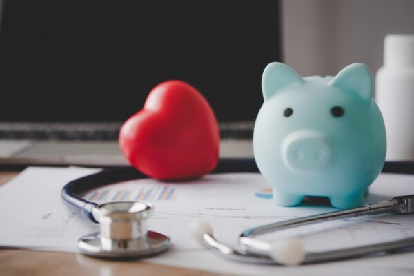 Medical Insurance Concept With Piggy Bank And Stethoscope On Wooden Desk