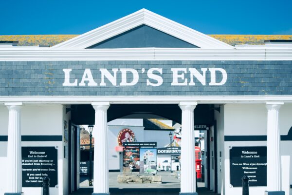 Land's end entrance displays white pillars and signage.