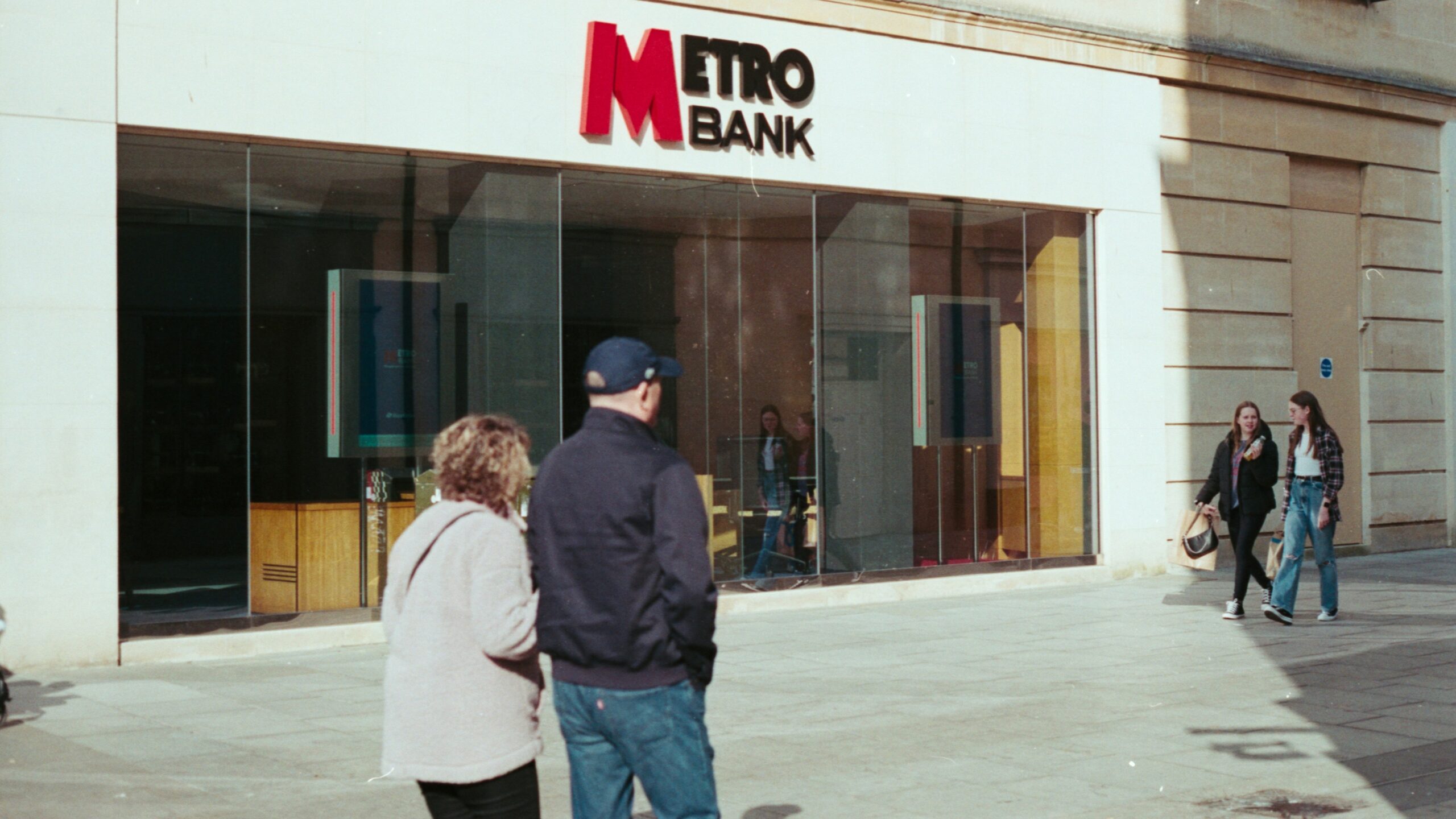 people walking in front of a store