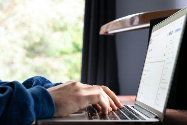 person using macbook pro on table