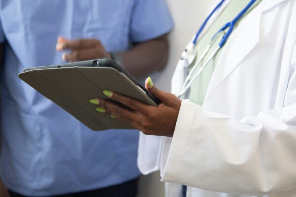 a doctor showing a patient something on the tablet