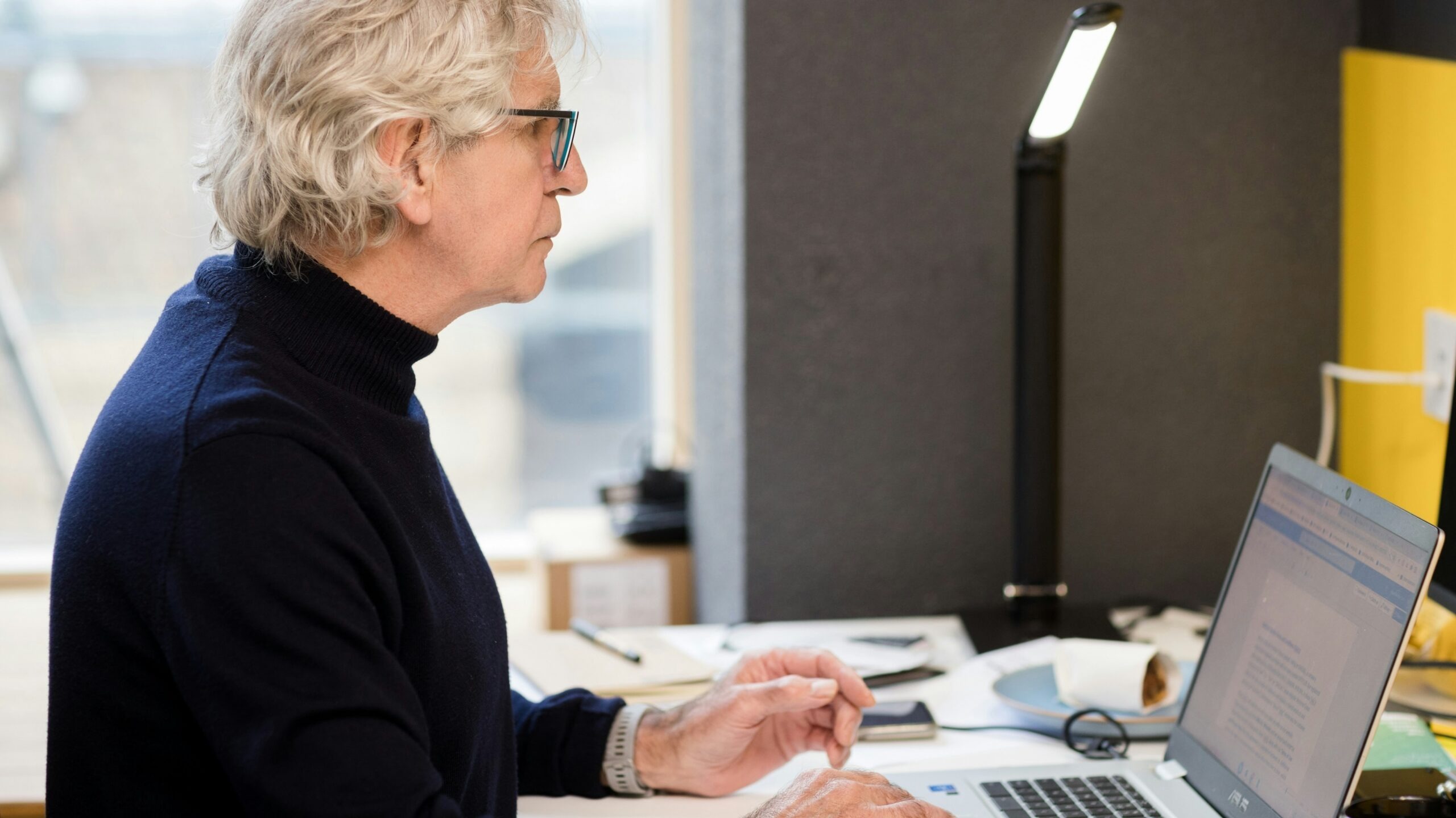 a woman sitting in front of a laptop computer