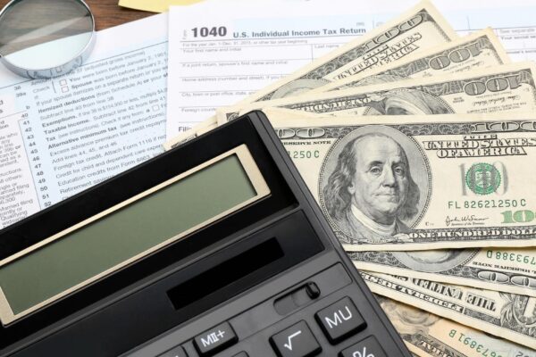 Calculator with money and documents closeup Tax concept