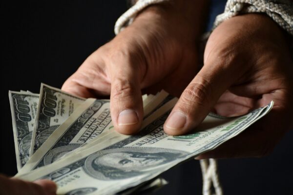 person holding 100 us dollar bill