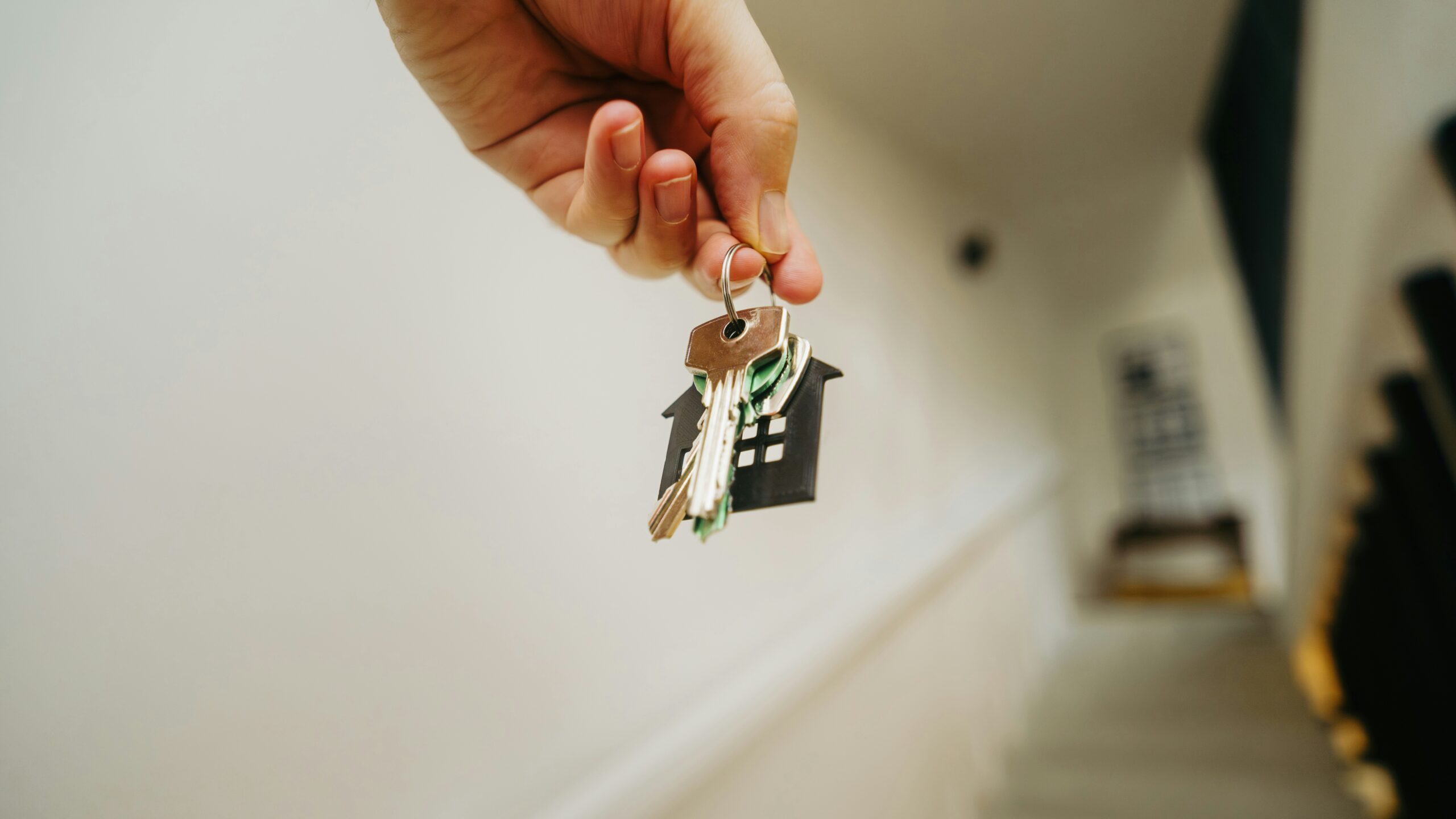 A person holding a house key in their hand