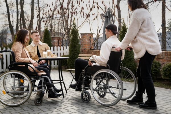A group of people in wheelchairs sitting around a table