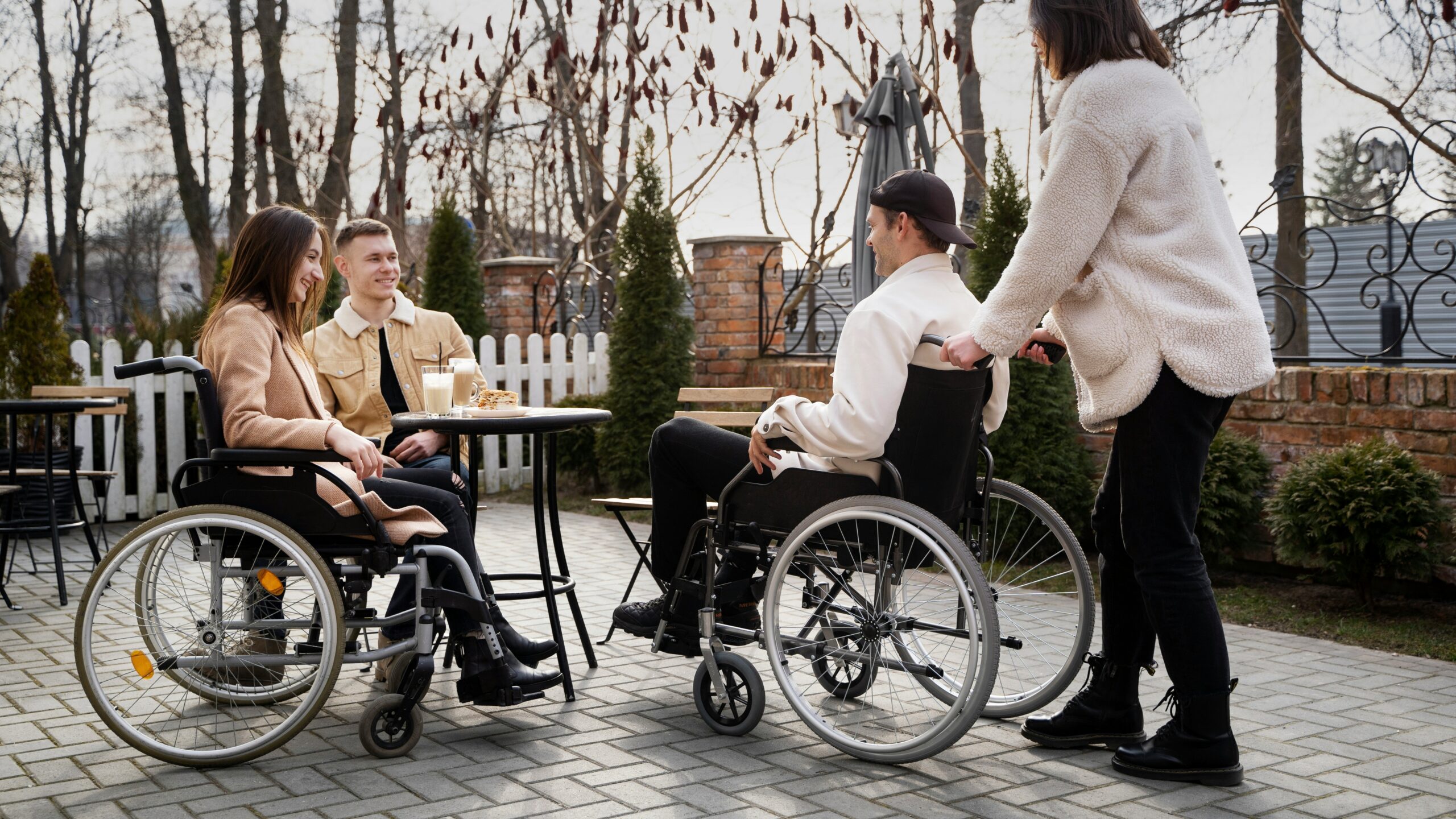 A group of people in wheelchairs sitting around a table