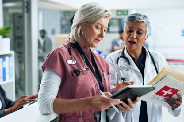 Doctor nurse and women with tablet for hospital management advice and consulting together Healthcare professional and medical team with digital app for online schedule agenda or report in clinic