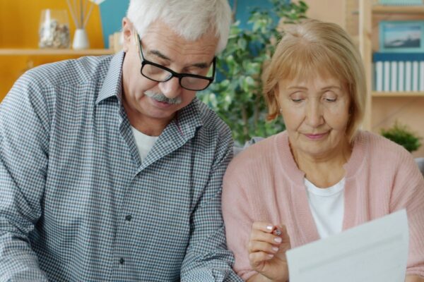 Elderly couple reviewing documents at home