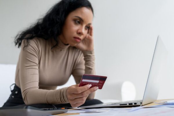 Stressed young woman has financial problems with credit card debt to pay crucial show concept of bad personal money and mortgage pay management crisis sad and unhappy