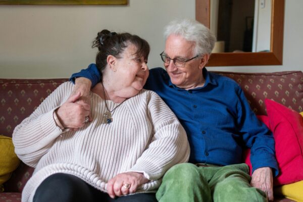 a man and woman sitting on a couch