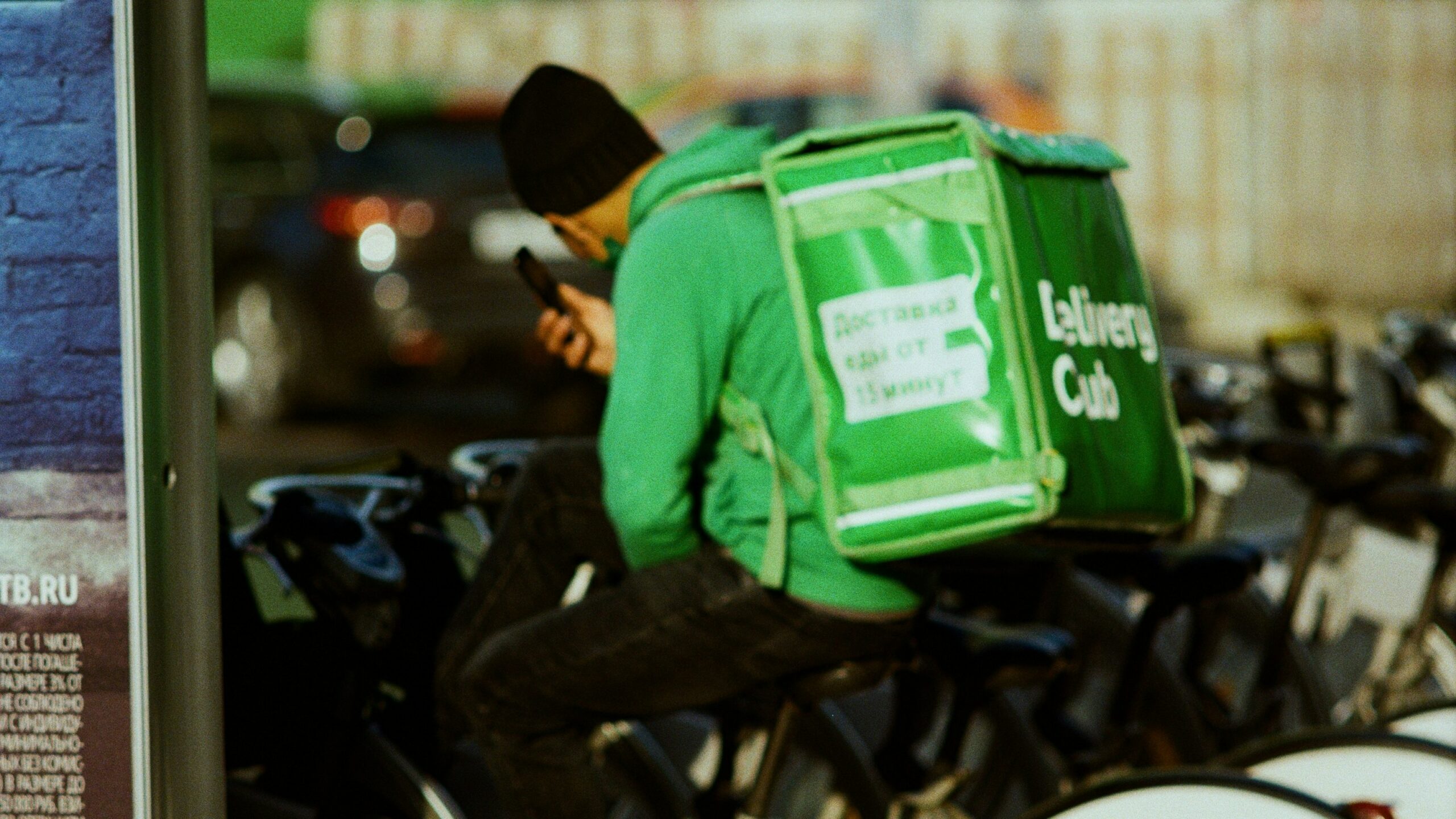 A man sitting on a bike with a bag on his back