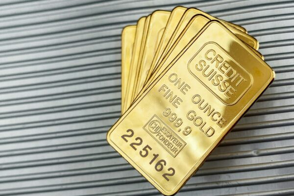 a group of gold cards sitting on top of a metal wall