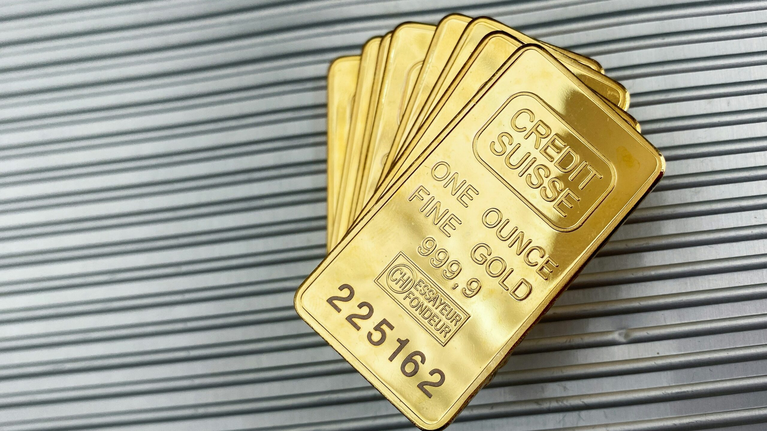 a group of gold cards sitting on top of a metal wall