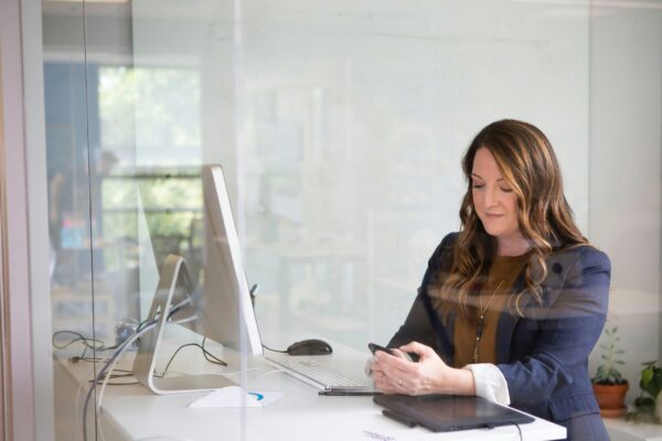 woman in black leather jacket using macbook air